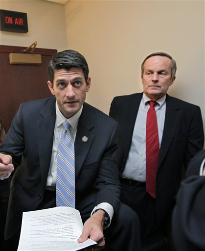 FILE - In this file photo of Tuesday, April 5, 2011, Missouri Congressman Todd Akin, right, a conservative Republican currently running for the U.S. Senate, listens to House Budget Committee Chairman Paul Ryan, R-Wis., before a news conference on Ryan's budget agenda, on Capitol Hill in Washington. Republican presidential candidate Mitt Romney's campaign on Sunday, Aug. 19, 2012 said Romney and his running mate, Rep. Paul Ryan, disagree with Akin's comments that a woman's body "has ways" to prevent pregnancy after rape. Romney spokeswoman Andrea Saul says Romney's administration would not oppose abortion in cases of rape. (AP Photo/J. Scott Applewhite, File)